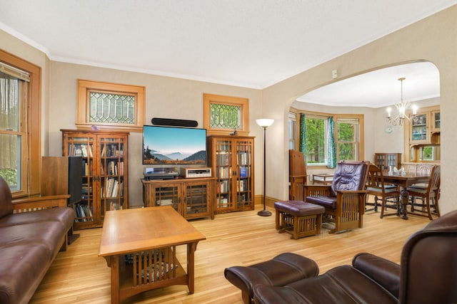 1757 Minnehaha Ave W, Saint Paul, MN 55104 - living area featuring arched walkways, a chandelier, wood finished floors, and ornamental molding