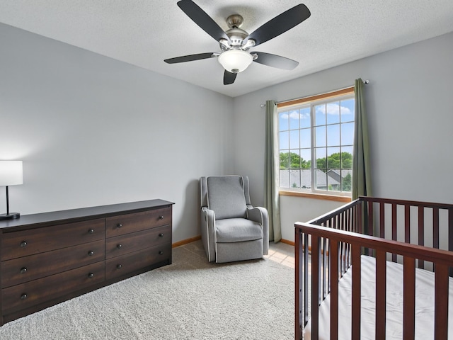 7647 Nicholas Way, Chanhassen, MN 55317 - bedroom featuring light colored carpet, a nursery area, ceiling fan, and baseboards