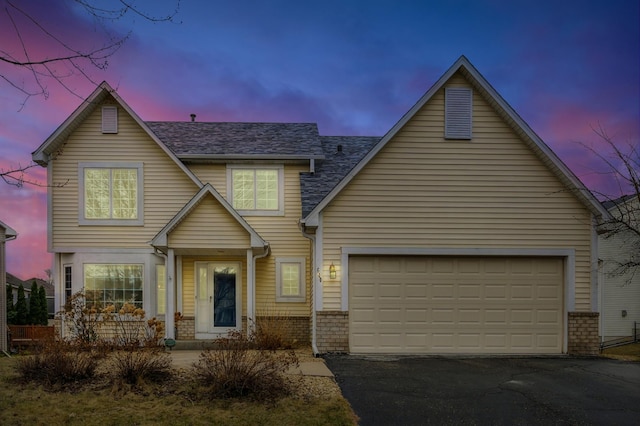 640 Falcon Ridge Rd, Woodbury, MN 55125 - view of front of house featuring asphalt driveway and a garage