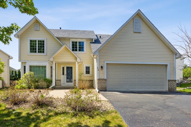 640 Falcon Ridge Rd, Woodbury, MN 55125 - view of front facade with driveway, roof with shingles, brick siding, and a garage