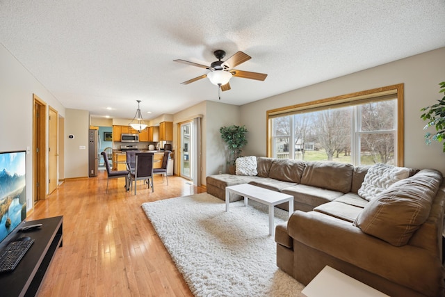 640 Falcon Ridge Rd, Woodbury, MN 55125 - living room featuring ceiling fan, light wood finished floors, a textured ceiling, recessed lighting, and baseboards