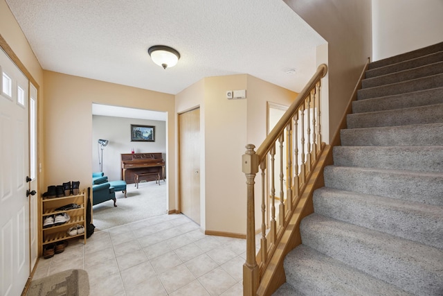 640 Falcon Ridge Rd, Woodbury, MN 55125 - foyer entrance with stairs, light colored carpet, a textured ceiling, and baseboards