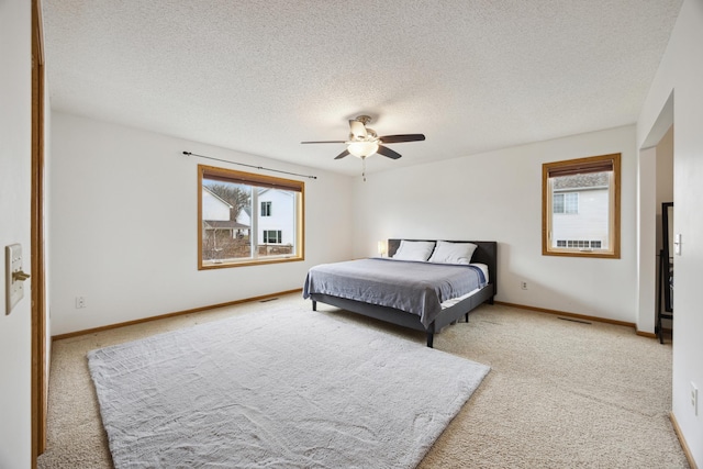 640 Falcon Ridge Rd, Woodbury, MN 55125 - bedroom featuring multiple windows, light colored carpet, a textured ceiling, and a ceiling fan