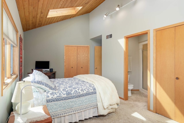 bedroom featuring carpet, visible vents, a skylight, and wood ceiling