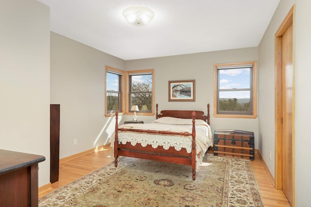 bedroom featuring baseboards and light wood-style flooring