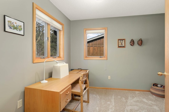 home office featuring baseboards, a wealth of natural light, and carpet