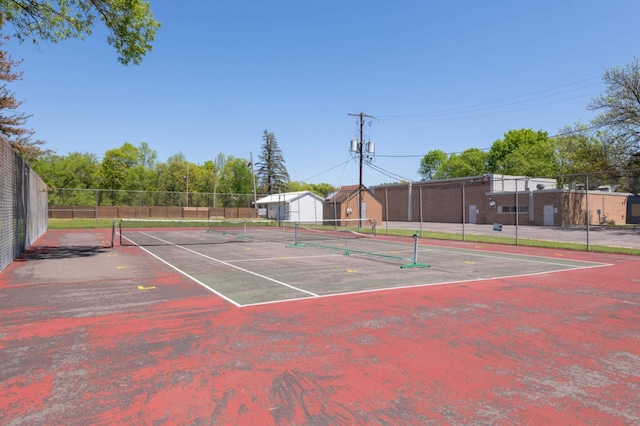 view of tennis court featuring fence
