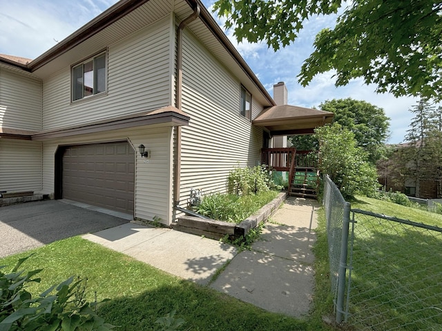 2545 Cedar Hills Dr, Minnetonka, MN 55305 - view of side of home featuring fence, driveway, and a garage