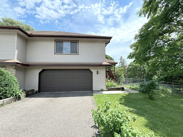 2545 Cedar Hills Dr, Minnetonka, MN 55305 - view of property exterior with a garage, a yard, aphalt driveway, and fence