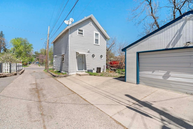 view of side of property featuring an outbuilding and a garage