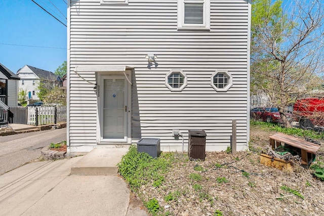 doorway to property featuring fence