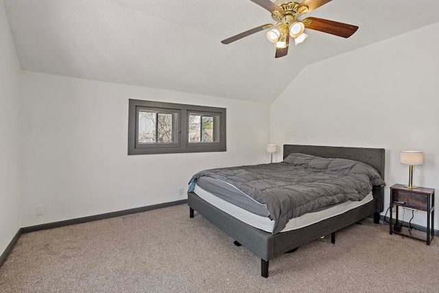 carpeted bedroom featuring baseboards, lofted ceiling, and ceiling fan