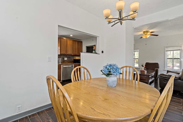 dining area with a chandelier, dark wood-style floors, baseboards, ceiling fan, and a textured ceiling
