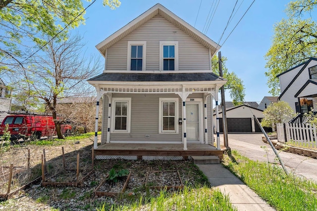 1213 26th St, Minneapolis, MN 55404 - view of front of home featuring covered porch, a detached garage, an outdoor structure, fence, and a shingled roof