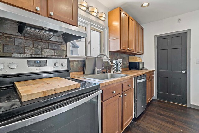 1213 26th St, Minneapolis, MN 55404 - kitchen with stainless steel appliances, extractor fan, a sink, dark wood finished floors, and backsplash
