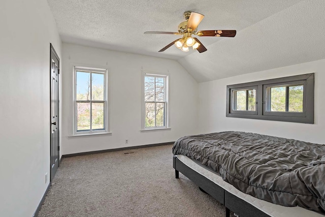 1213 26th St, Minneapolis, MN 55404 - bedroom with carpet, a textured ceiling, baseboards, vaulted ceiling, and ceiling fan