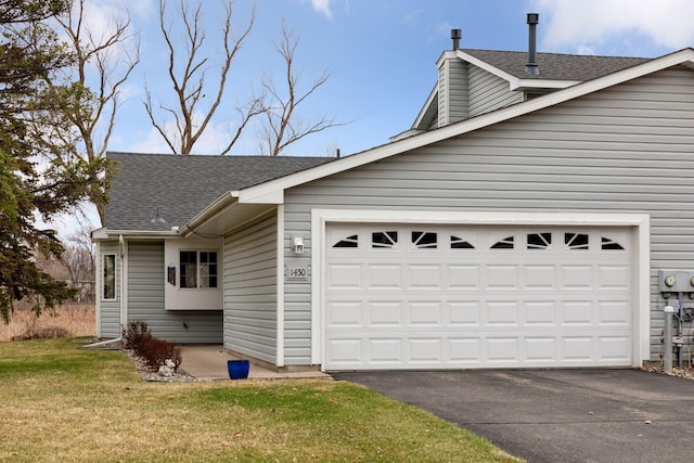 view of home's exterior with a chimney, an attached garage, a lawn, a shingled roof, and aphalt driveway