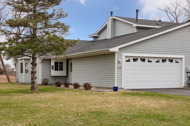 view of front of house with a garage, driveway, a front yard, and roof with shingles