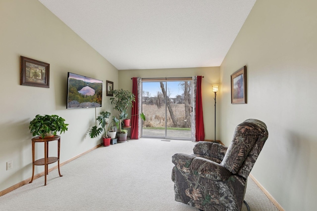 living area featuring baseboards, vaulted ceiling, and carpet flooring