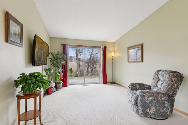 sitting room with baseboards, carpet flooring, and vaulted ceiling