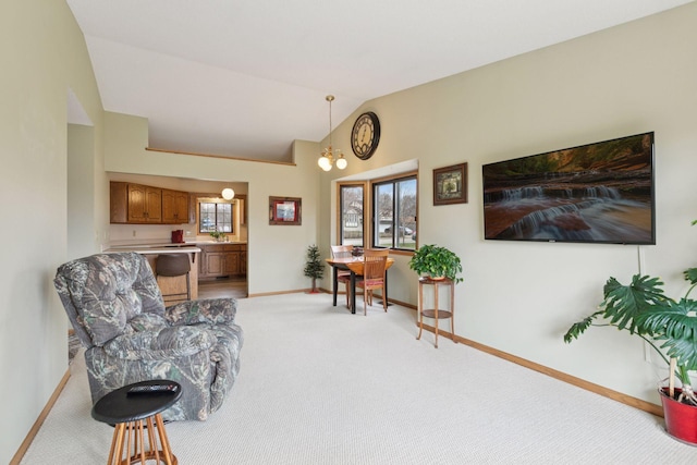 sitting room featuring lofted ceiling, light carpet, and baseboards