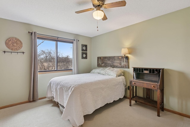 carpeted bedroom featuring a ceiling fan and baseboards