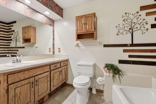 full bathroom with a bath, baseboards, vanity, and toilet