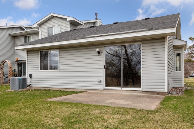 back of property featuring central AC, roof with shingles, a yard, and a patio area