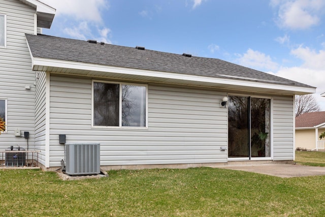 back of property featuring a lawn, central AC unit, and a patio