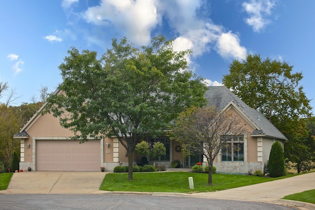 obstructed view of property featuring brick siding, a garage, concrete driveway, and a front yard