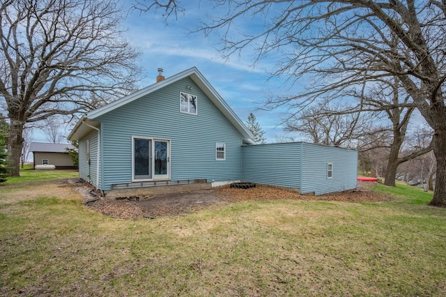 rear view of property featuring a yard