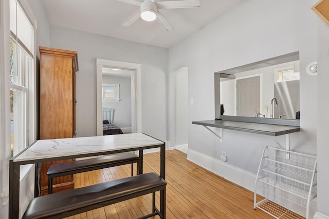 2822 29th St, Minneapolis, MN 55406 - dining area with ceiling fan, light wood-style floors, and baseboards
