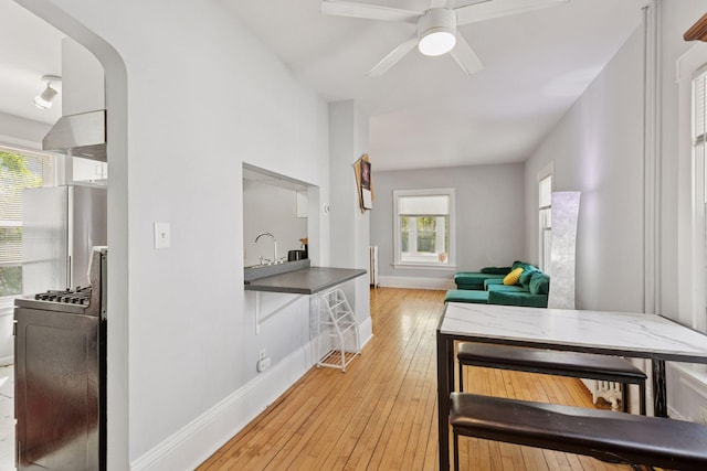 2822 29th St, Minneapolis, MN 55406 - hall featuring light wood finished floors, baseboards, and a sink