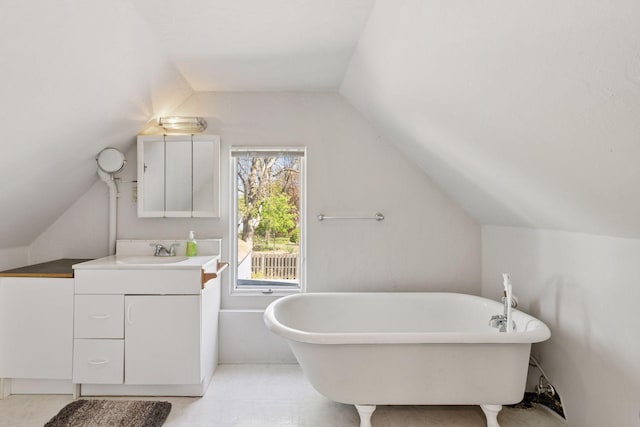 2822 29th St, Minneapolis, MN 55406 - bathroom with vaulted ceiling, a soaking tub, and vanity