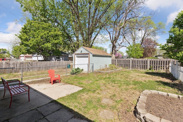 2822 29th St, Minneapolis, MN 55406 - view of yard with a detached garage, an outbuilding, and a patio