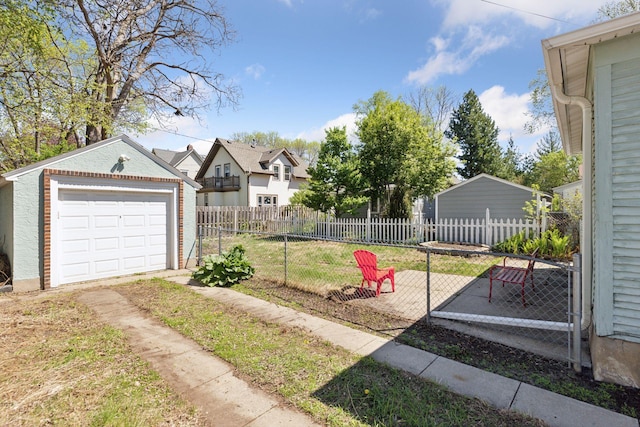 2822 29th St, Minneapolis, MN 55406 - view of yard featuring an outbuilding, a garage, and driveway