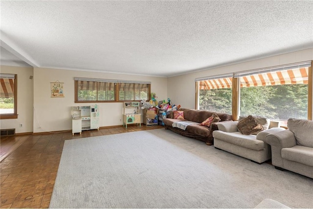 2411 Mcmenemy St, Little Canada, MN 55117 - living area featuring visible vents, baseboards, and a textured ceiling