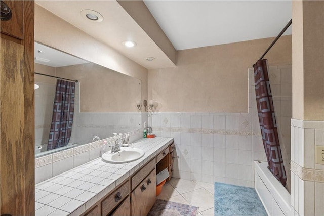 2411 Mcmenemy St, Little Canada, MN 55117 - bathroom featuring vanity, tile patterned flooring, a wainscoted wall, tile walls, and shower / bath combo with shower curtain