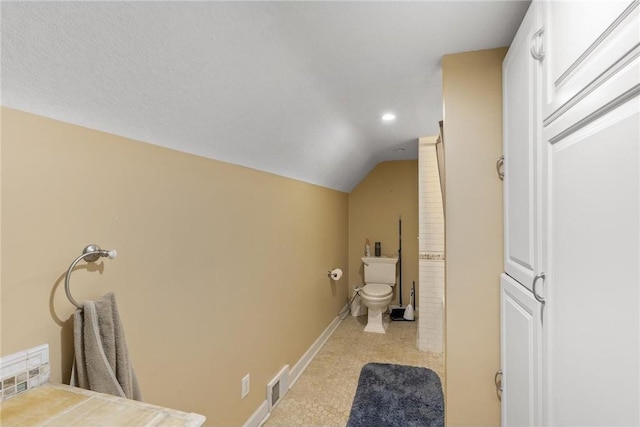 2411 Mcmenemy St, Little Canada, MN 55117 - bathroom with baseboards, recessed lighting, toilet, visible vents, and lofted ceiling