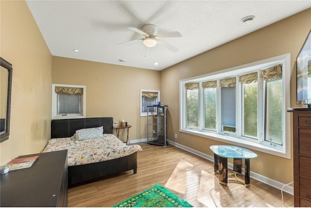 2411 Mcmenemy St, Little Canada, MN 55117 - bedroom with light wood-style floors, visible vents, baseboards, and a ceiling fan