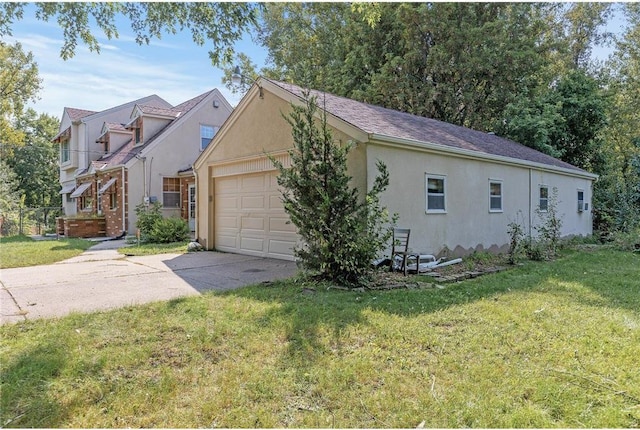 2411 Mcmenemy St, Little Canada, MN 55117 - view of property exterior featuring stucco siding, a lawn, a garage, and concrete driveway