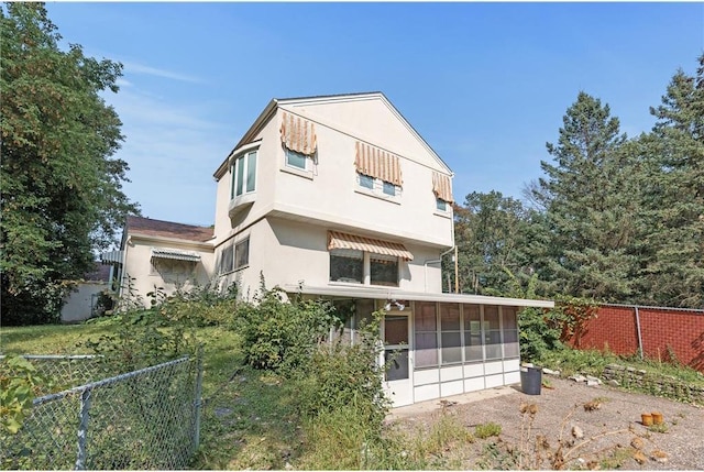 2411 Mcmenemy St, Little Canada, MN 55117 - rear view of property with a sunroom, stucco siding, and fence