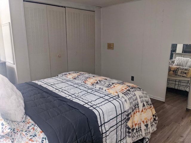 513 5th Ave, Ironton, MN 56455 - bedroom with wood finished floors, a closet, and baseboards