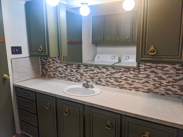 513 5th Ave, Ironton, MN 56455 - bathroom featuring washing machine and dryer, backsplash, and vanity