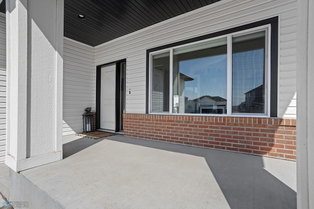 5497 11th St W, West Fargo, ND 58078 - property entrance featuring brick siding and a patio