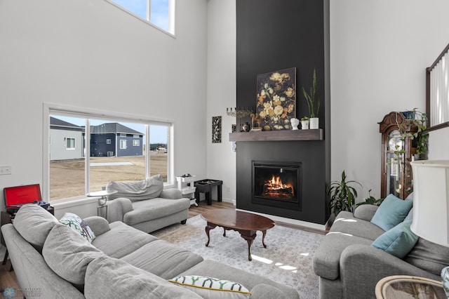 5497 11th St W, West Fargo, ND 58078 - living room with wood finished floors, a towering ceiling, and a large fireplace