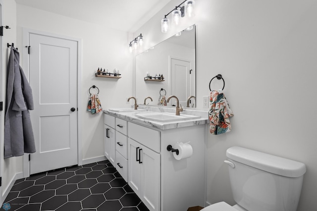 5497 11th St W, West Fargo, ND 58078 - bathroom with tile patterned flooring, a sink, double vanity, and toilet