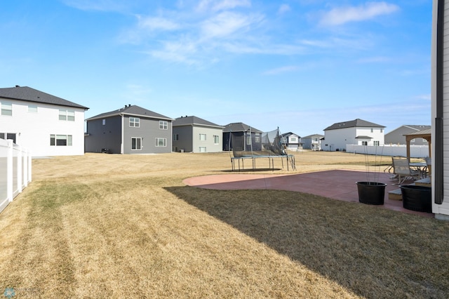 5497 11th St W, West Fargo, ND 58078 - view of yard featuring fence, a residential view, a patio, and a trampoline