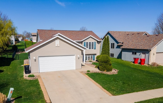 traditional home with driveway, a shingled roof, a front yard, and a garage