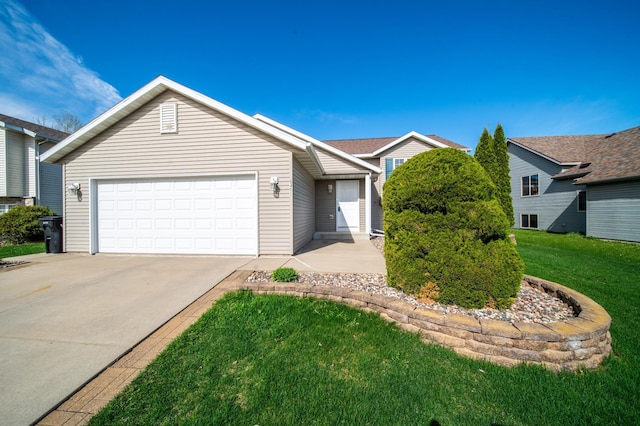 ranch-style home featuring an attached garage, driveway, and a front yard